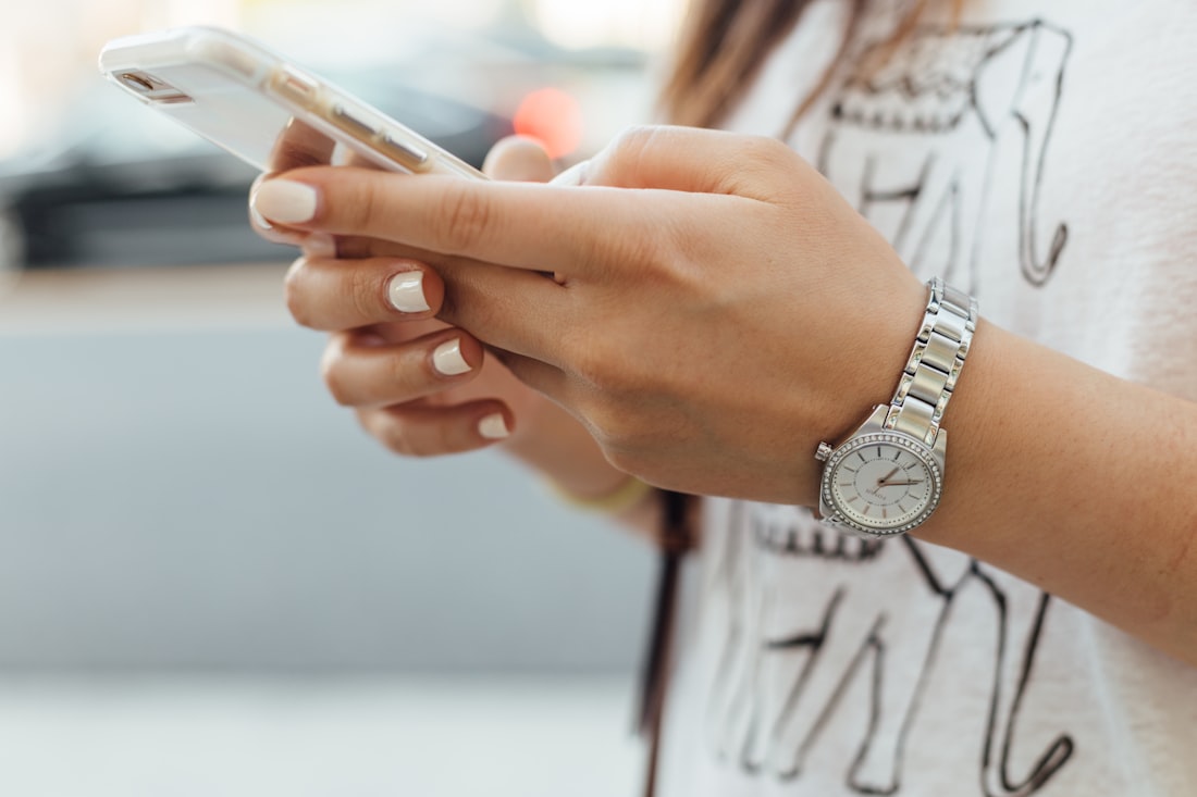 A person reading information on their smartphone