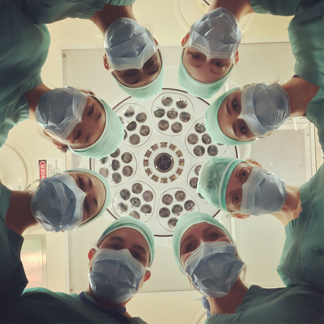 A team of healthcare workers in scrubs gathered together